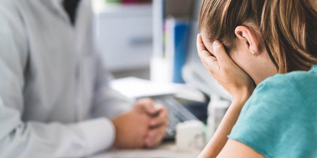 Pharmacist consulting distraught patient