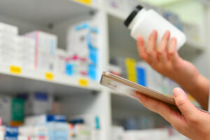 Pharmacist looking at generic bottle