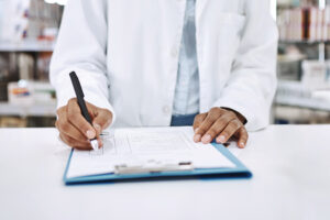 Pharmacist writing on a clipboard
