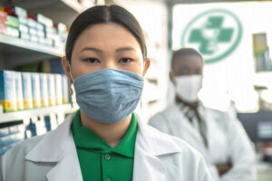 Pharmacist and pharmacy technician with masks