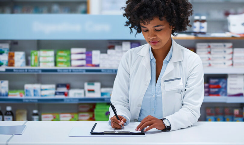 Pharmacist with checklist at counter
