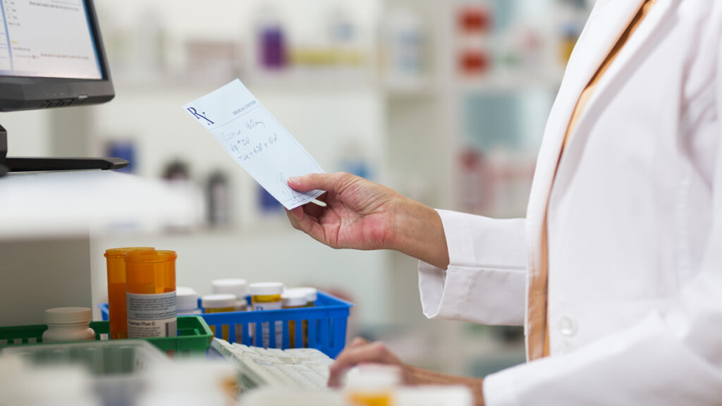 pharmacist checking prescription