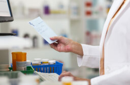 pharmacist checking prescription